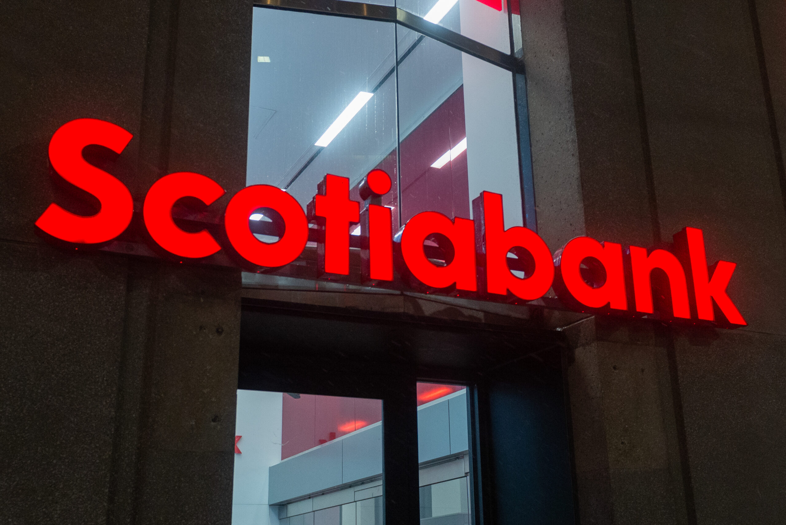 Toronto, ON, Canada  December 05, 2021: The logo and brand sign of Scotiabank in downtown Toronto.  The Bank of Nova Scotia  is a Canadian multinational banking and financial services company