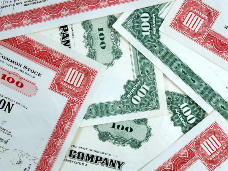 Red and green share certificates. Bull & bear - stock market. Old, vintage, retro shares. Common stock & bonds.