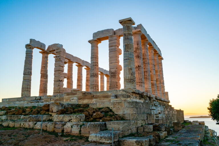 ancient columns of parthenon against blue sky